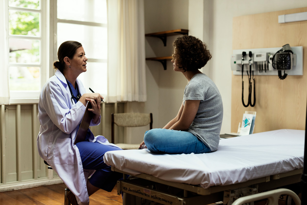 Doctor speaking with patient in examination room